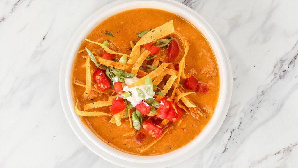 Chicken Tortilla Soup · Chicken simmered in a tomato and chicken broth with pepper-jack cheese, garnished with tortillas, sour cream, diced tomatoes and green onions