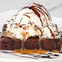 Chocolate Brownie · Salted caramel sauce, dark chocolate sauce and a scoop of vanilla ice cream