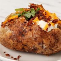Loaded Baked Potato  · Large Idaho potato topped with whipped butter, sour cream, smoked cheddar cheese, apple wood...
