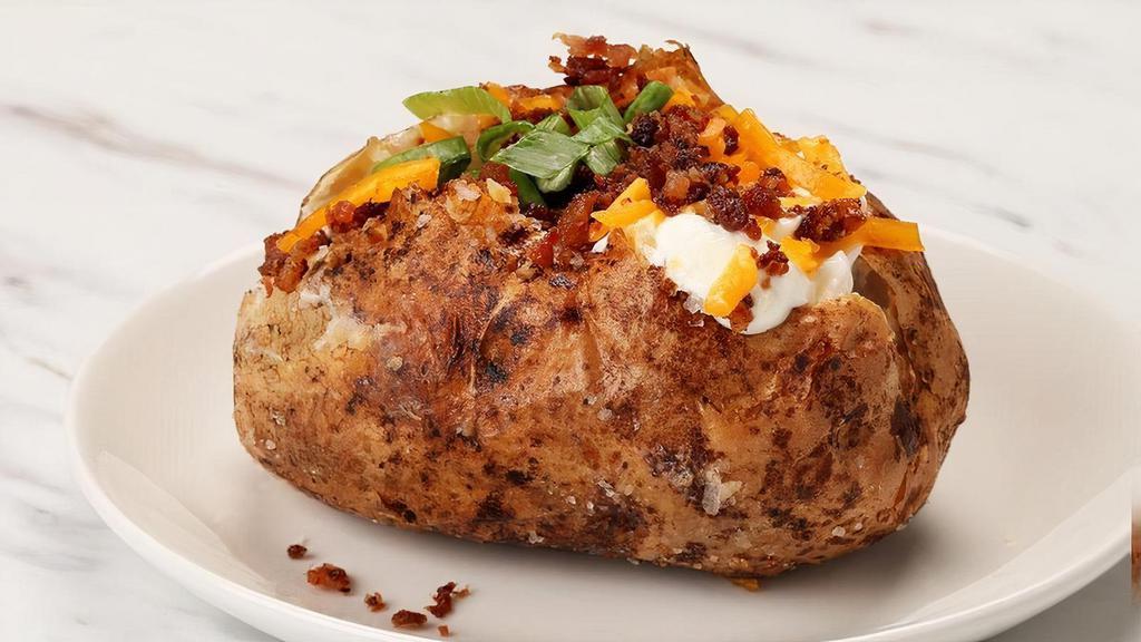 Loaded Baked Potato  · Large Idaho potato topped with whipped butter, sour cream, smoked cheddar cheese, apple wood smoked bacon and green onions