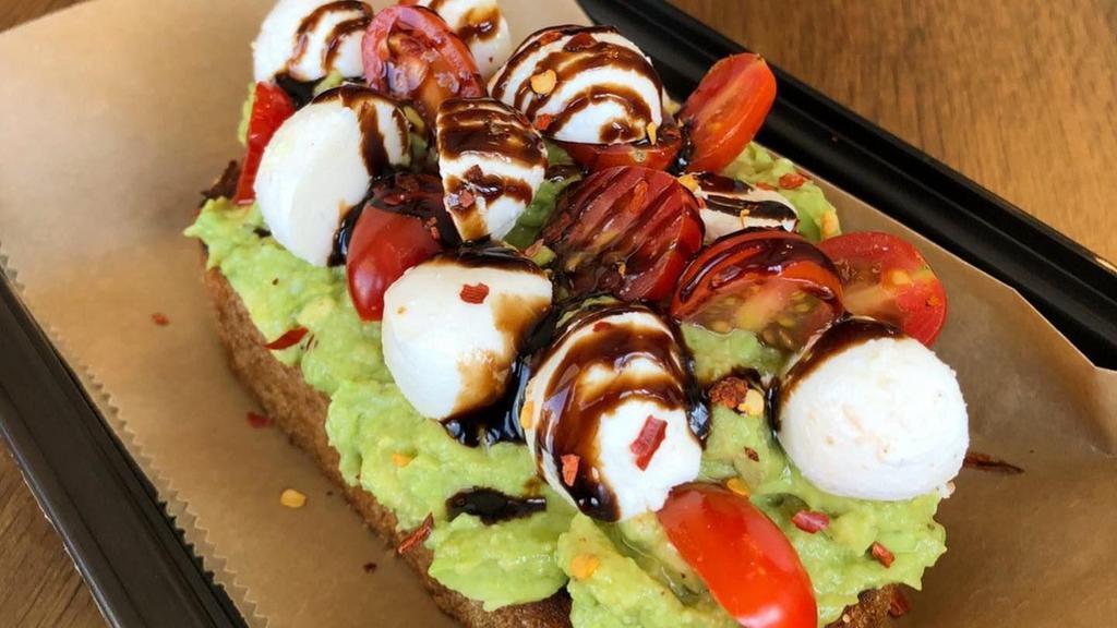 Caprese Toast · Avocado spread, cherry tomatoes, fresh mozzarella, red pepper flakes, balsamic reduction, drizzled with extra-virgin olive oil.