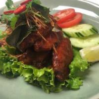 Chicken Wings · Spicy deep fried marinated tom yum flavor wings with Thai herbs garnish. Spicy.