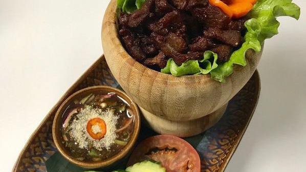Moo Sawan · Fried marinated Thai herbs pork Served with spicy tamarind sauce.