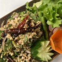 Larb Gai · Spicy Thai chicken salad. Minced chicken, chili powder, roasted rice powder red onion, mints...