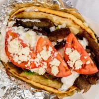 Classic Gyro · Four ounces of freshly sliced and grilled gyro topped with lettuce, onions, tomato and tzatz...