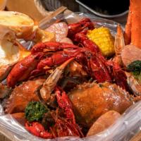 #4 Combo Snow Crab 1 Cluster, 1/2 Shrimp Head Off, 1/2 Green Mussel · Served w/ 2 corn and 2 Potatoes  and Choice of Your Favorite Seasonings and Spice Level!