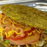 Patacon · Green plantain, lettuce, tomatoes, cheese, nero sauce and choice of ham and cheese, chicken,...