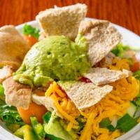 South American Taco Salad · A classic taco salad with Romaine lettuce, tomatoes, cucumbers, a savory blend of guacamole,...