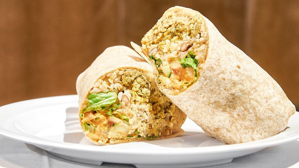 Baked Falafel Burrito · Vegetarian. Baked falafel, hummus, brown rice, chili beans, cucumbers, Romaine, tomatoes, hot sauce and tahini in a whole wheat wrap. With brown rice, made spicy upon request.