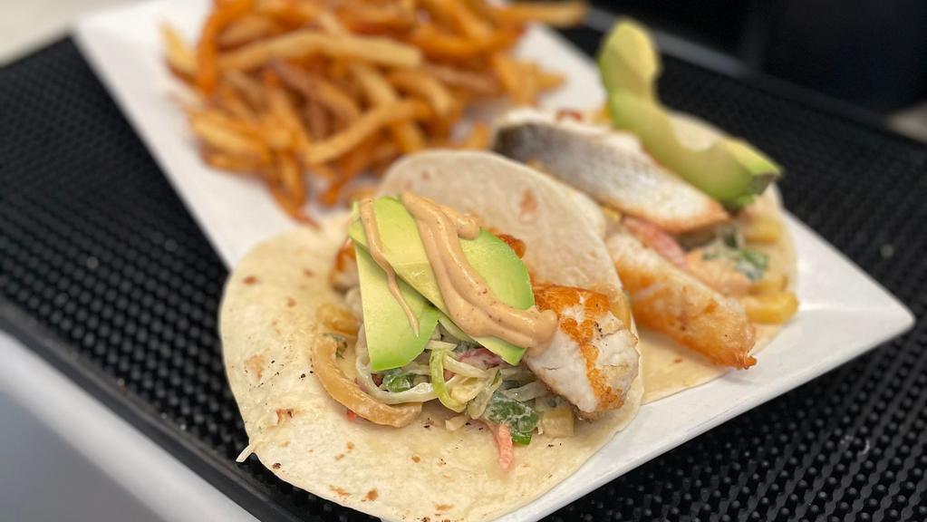 Seabass Tacos · two (2) seabass tacos in flour tortillas, topped with mango slaw, sliced avocado & chipotle aioli