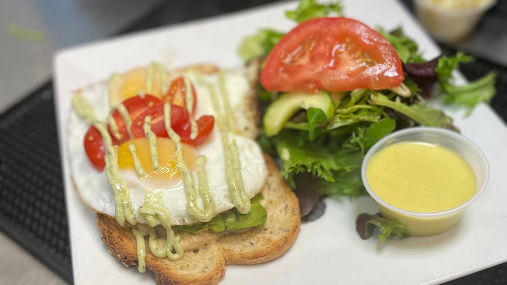 Hummus Avocado Toast · multi-grain toast, hummus, and sliced avocado, topped with 2 sunny side up eggs, served with home fries or salad