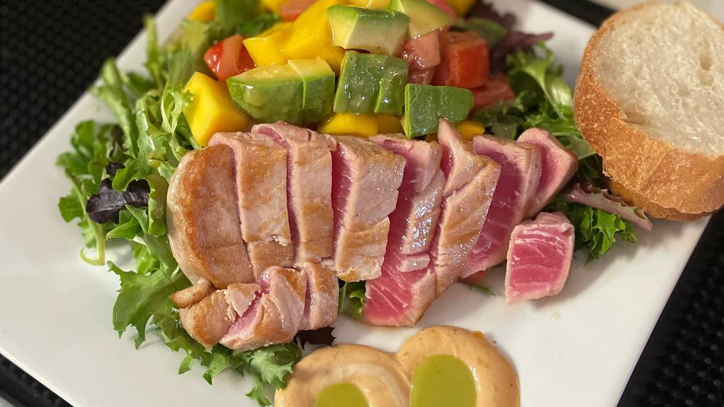 Yellowfin Tuna Salad · Seared sushi grade tuna with a chipotle, cilantro and lime sauce, mixed greens, mango, avocado, tomato .
