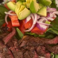 Steak Salad · Grilled marinated hanger steak with mesclun greens, avocado, red onion and tomato with lemon...