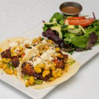 Baja Fish Tacos · Blackened tilapia served in two flour tortillas with roasted pineapple salsa, fresh guacamol...