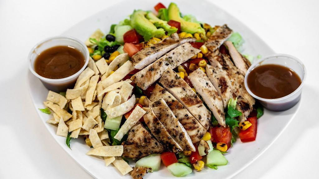 Fresh Stop Salad · Grilled chicken, romaine, black beans, roasted corn, cucumbers, tomatoes, wontons, and avocado with balsamic vinaigrette dressing.