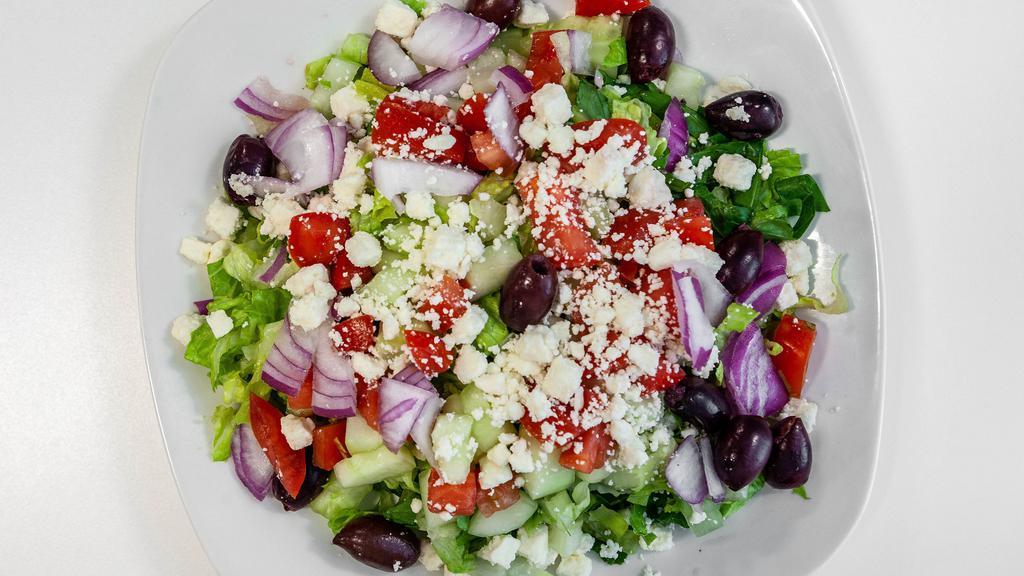 Greek Salad · Romaine, feta cheese, olives, red onion, grape leaves, tomatoes, and cucumbers with oil and vinegar dressing.