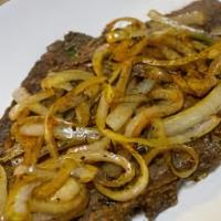 Bistec Encebollado · Spanish style steak with sautéed onions.