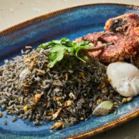 Khao Phad Pla Mueng · Squid ink fried rice, octopus, poached egg, cilantro, onion and fried garlic.