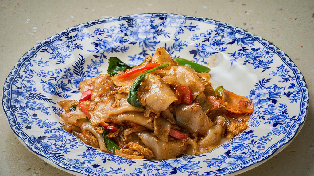 Gauy Tiew Pad Kee Mau · Wok-fried spicy flat noodle with choice of meat, egg, basil leaves, onion, carrot and bell peppers.