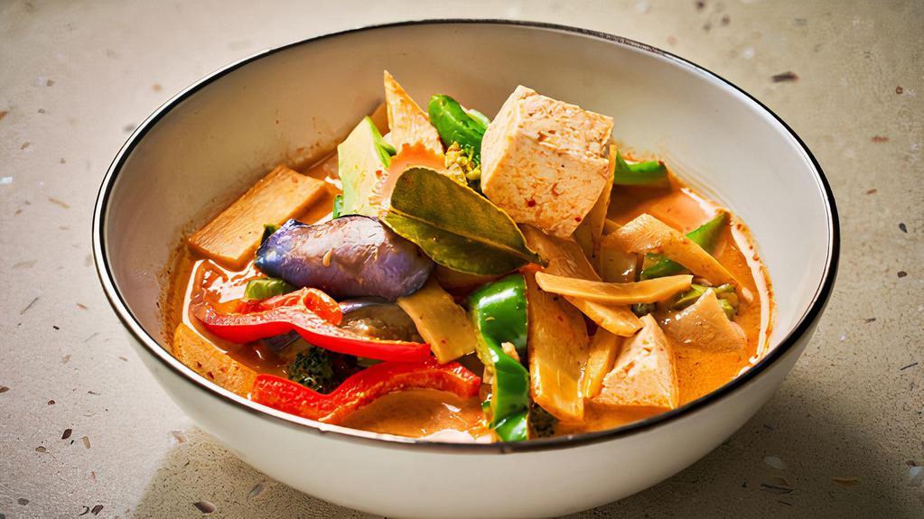 Gaeng Dang · Thai style red curry with bamboo shoot, basil leaves, carrot, eggplant and bell pepper simmered in coconut milk.