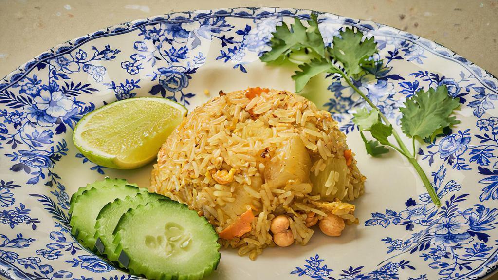 Khao Phad Sup Pa Rod · Pineapple fried rice with choice of meat, yellow curry powder, cilantro, cashew nut, carrot, egg and onion.
