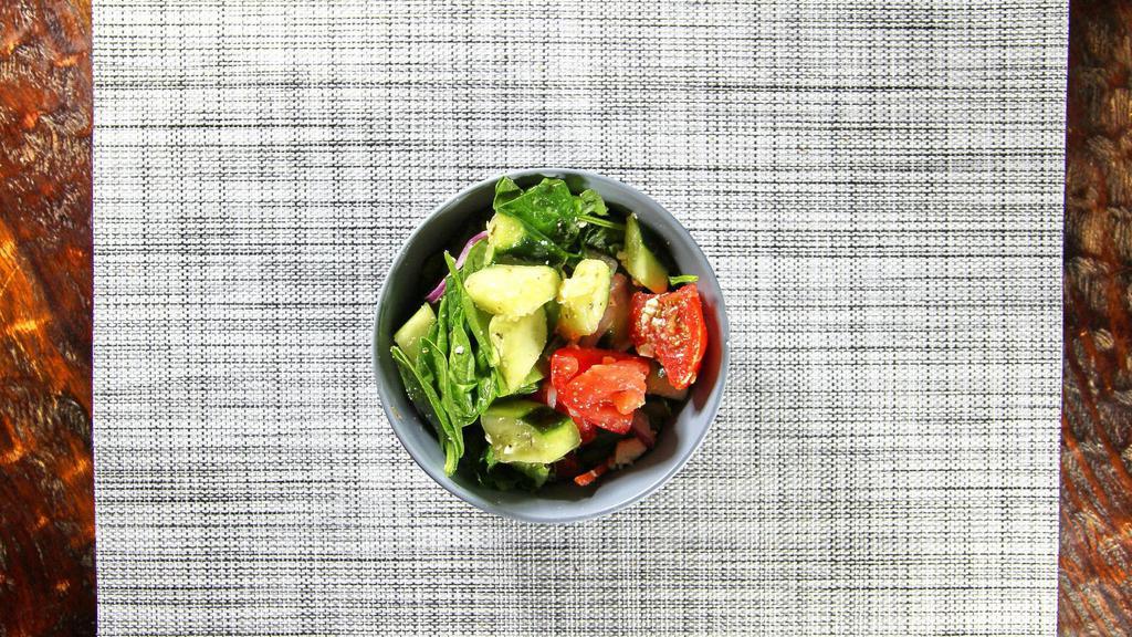 Greek Salad · Iceberg lettuce, cucumbers, green peppers, tomatoes, onions, olives, stuffed grape leaves, and feta cheese.