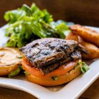 Jerk Chicken Burger · Jerk marinated chicken, lettuce, tomato, jerk mayo. Served with sweet plantains and mixed gr...