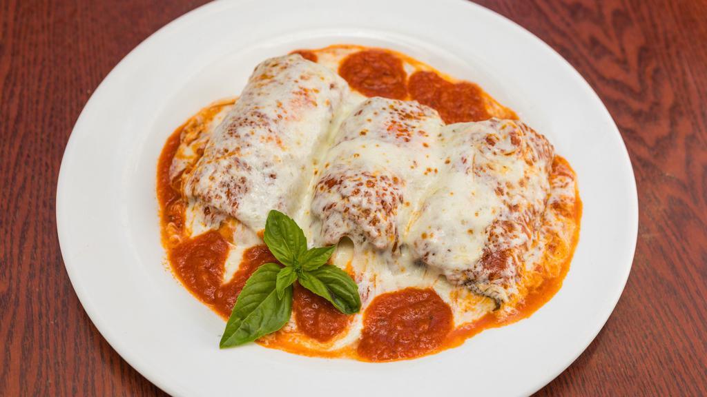 Eggplant Rollatini · Ricotta, Romano, and mozzarella filling rolled up into an egg battered slice of eggplant, topped with pasta lover's tomato sauce and melted mozzarella.