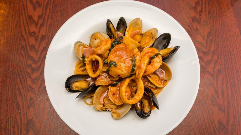 Linguine Frutti Di Mare · Sautéed calamari, shrimp, clams, mussels, and scallops are married together in a flavorful tomato seafood sauce.
