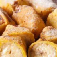 Banana Pakora (4 Pcs) · Four pieces. Soft and spongy fritters stuffed with ripe bananas.