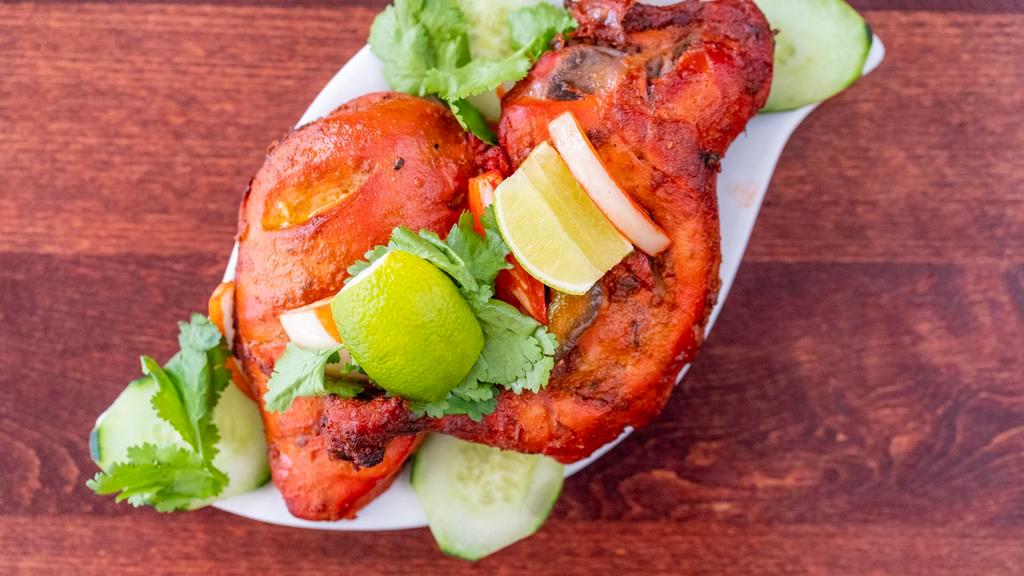 Tandoori Chicken · Spring chicken marinated in special yogurt marinade with freshly ground spices then barbecued to perfection.