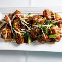 Gobi Manchurian (Gravy) · Fried patties of chopped vegetables cooked in manchurian sauce.
