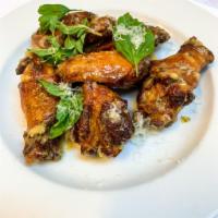 Italian Wings · Wings tossed with slow roasted garlic, aged parmesan cheese and fresh herbs.