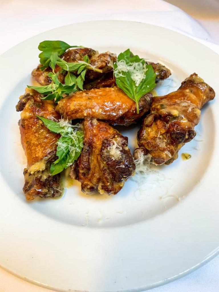 Italian Wings · Wings tossed with slow roasted garlic, aged parmesan cheese and fresh herbs.