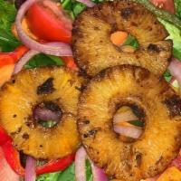 Pineapple Jerk Salad · Mixed greens, carrots, and Tomatoes with sauteed bell peppers, red onions and pineapple slic...