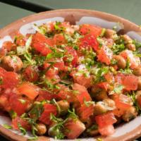 Foul · Fava beans, tomatoes, garlic, parsley, scallion and lemon.
