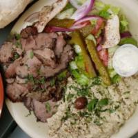 Leg Of Lamb Platter · Finely roasted leg of lamb slices served with a house green salad, freshly baked pita bread,...