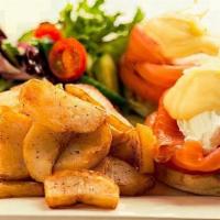 Salmon Eggs Benedict · Poached eggs, salmon, and hollandaise sauce. Served on English muffin with fries and salad.