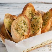 Garlic Bread · Crispy bread baked to perfection, topped with fresh garlic and herb seasoning.