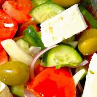 Tomato Salad · With cucumbers, onions, peppers, olives and feta cheese.
