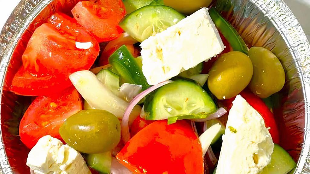 Tomato Salad · With cucumbers, onions, peppers, olives and feta cheese.