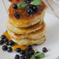 Blueberry Pancakes · Fluffy, buttery, light pancakes marbled with juicy blueberries. Served with maple syrup.