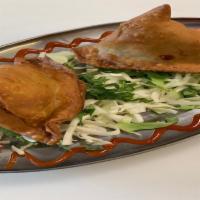 Chicken Samosa · Homemade pastries stuffed with ground chicken and peas.