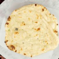 Naan · Soft leavened white flour bread baked in clay oven.