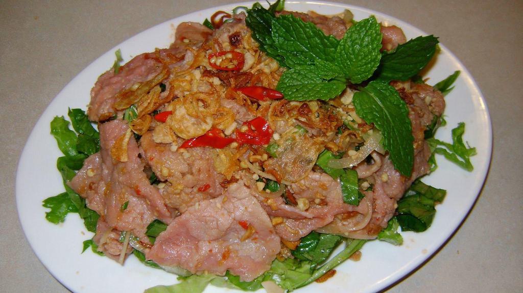 Lemon Beef Salad · Slices of rare beef in special mixture of toasted peanuts, fried onion flakes and Chinese parsley in combination of tomato slices, lemon juice, cucumber and house special salad dressing, garnished with romance lettuce.