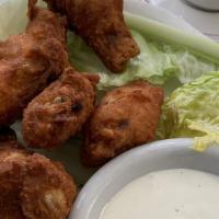Buffalo Wings · With blue cheese dressing and celery sticks.