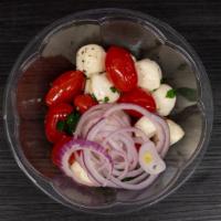 Mozzarella & Tomato Salad · Fresh mozzarella, tomatoes, red onions, olive oil, oregano and balsamic.