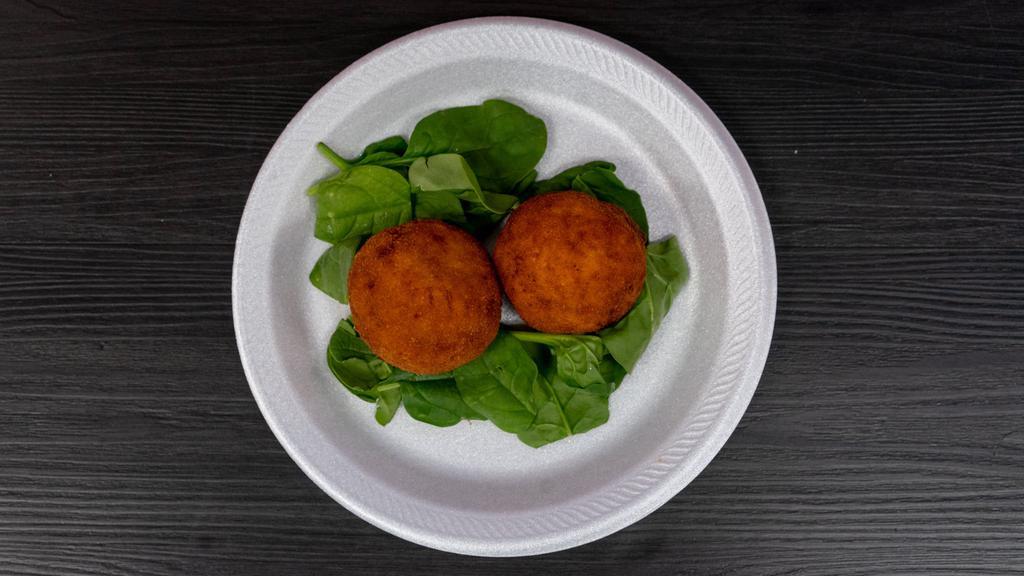 Rice Ball (Orangina) · Two rice balls breaded and fried stuffed with beef and mozzarella, served with a a side of marinara sauce.