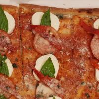 Crispino Pizza · Thin Crispy Sicilian topped with fresh Mozzarella, Tomato, Roasted Peppers and Basil.