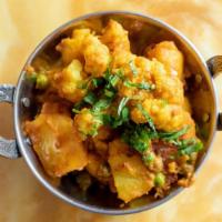 Alu Mattor Gobi · Served w/ Basmati Rice. Potatoes green peas & cauliflower cooked w/ fresh spice sauce.